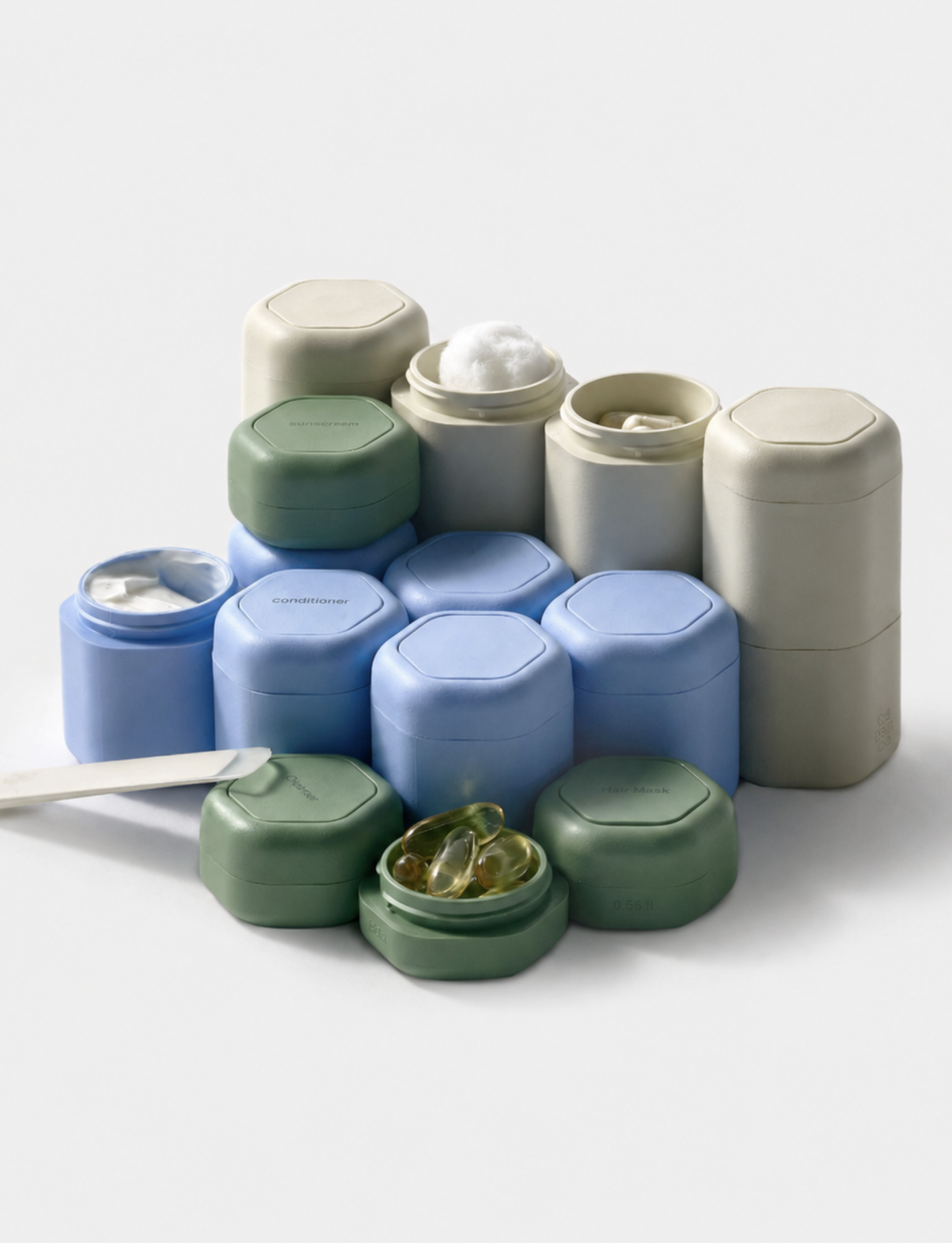 Stacked Cadence travel capsules in blue, green and cream